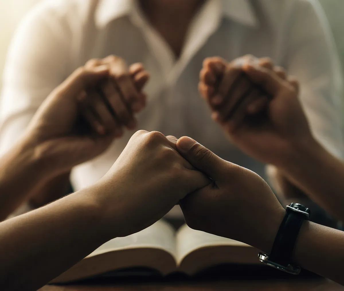 People holding hands for prayer