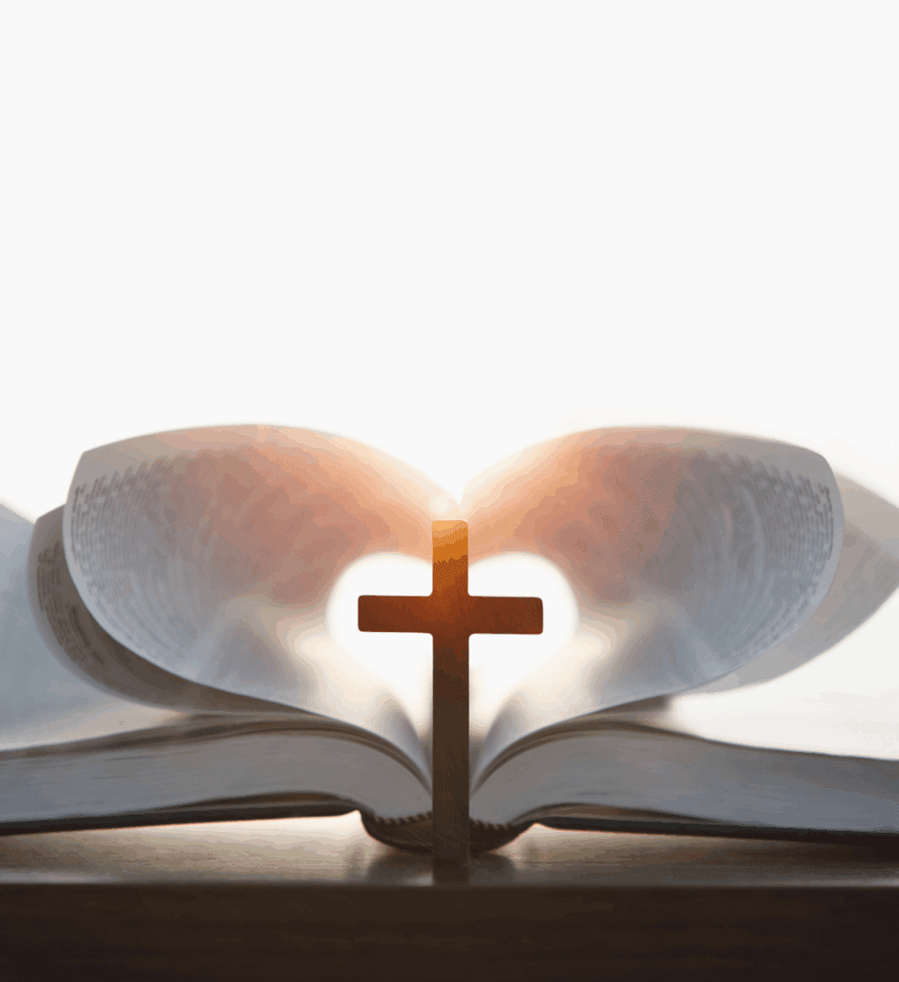 A wooden cross casting a shadow on an open Bible with sunlight shining through.
